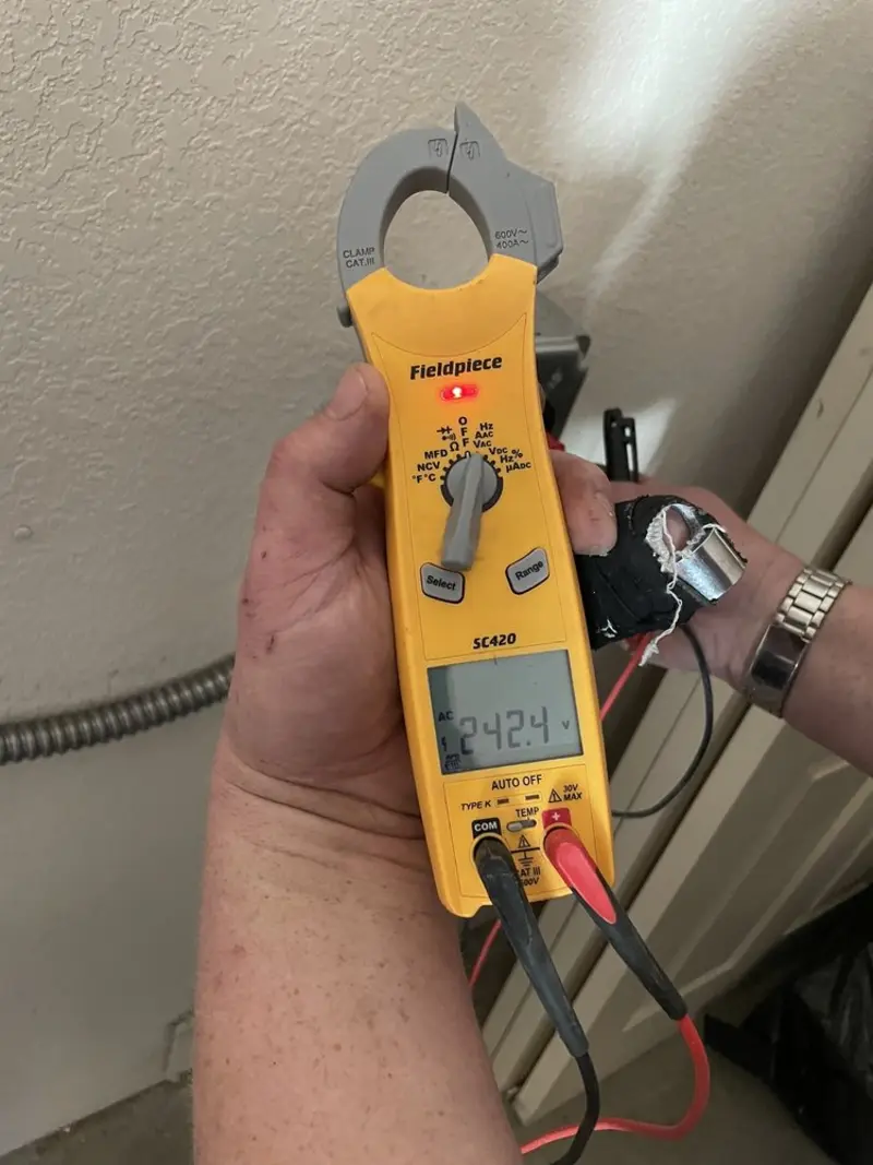 Voltage testing with clamp meter during Recessed Lighting Installation in New Boston